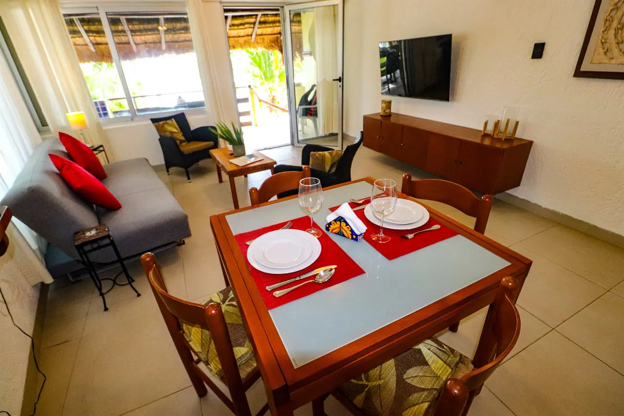 Dining table set for four next to the living area