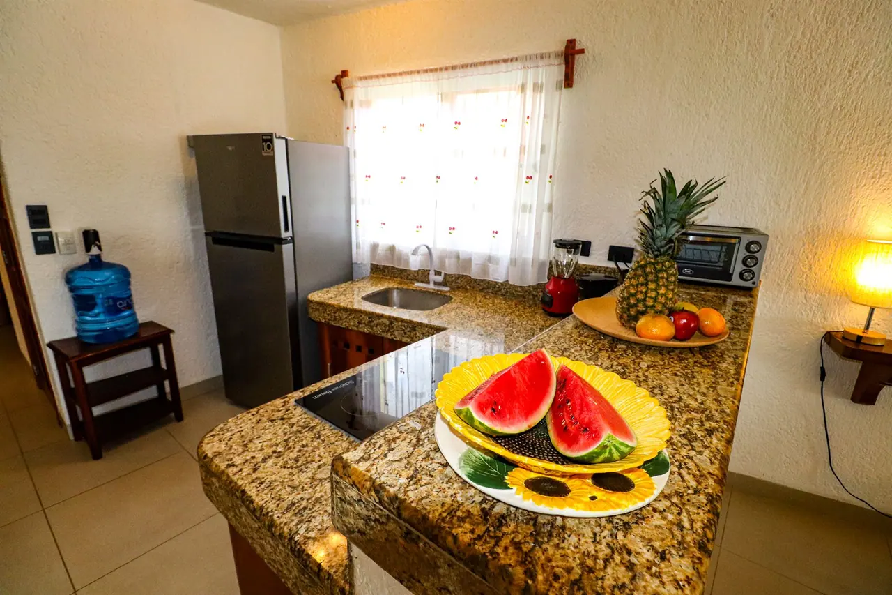 Kitchen with granite counter and fresh fruit
